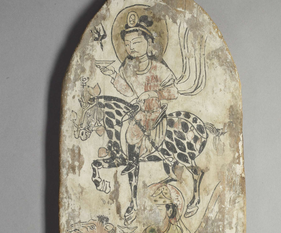 Todennäköisesti buddhalainen votiivitaulu, maalattu puu. Löytöpaikka: Dandan-Uilig, Khotan, Xinjiang, Kiina. Nykyään British Museumissa. Löytäjä: Aurel Steinin retkikunta, 1900–01. Kuvassa näkyy ainoastaan votiivitaulun yläosa, johon on maalattu mieshahmo, joka ratsastaa tiikerinkirjavalla eli täplikkäällä hevosella. Mieshahmolla on pitkä musta tukka, ohuet kaartuvat viikset ja diademi, jossa otsan päällä on kiekko tai pyöreä koriste. Hänellä on päässään sädekehä. Mies on pukeutunut väljään tunikaan ja korkeisiin saappaisiin. Hän pitää oikeassa kädessään matalaa kulhoa. Vasemmassa yläkulmassa on musta korppi tai varis.