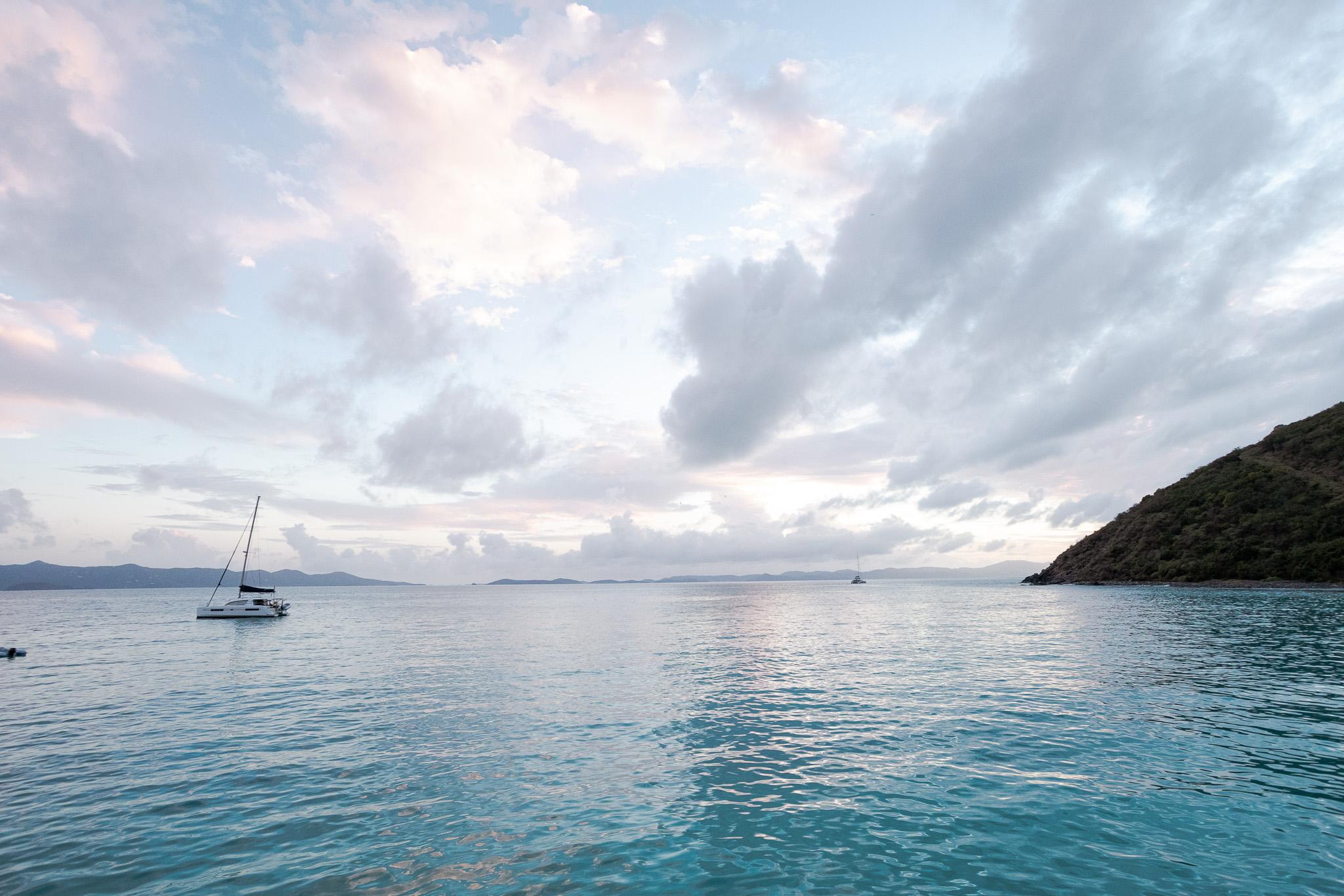 caribbean blue water at twilight with pastel clouds in background