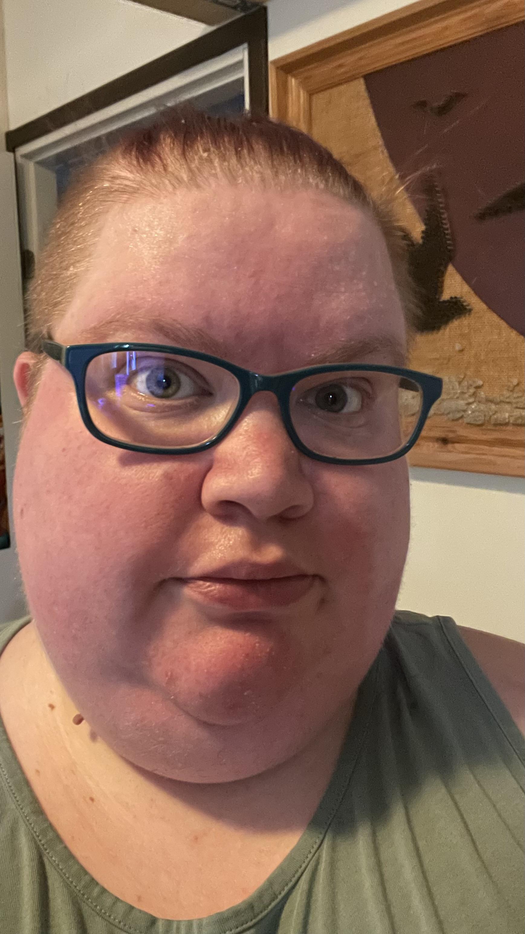 A selfie of me wearing a pair of glasses with green frames. My face has an incredulous look on it as I never imagined seeing these glasses again!